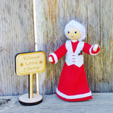 Mrs. Claus doll with Kindness Elves sign