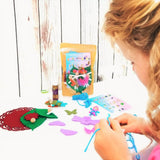 Little girl making bendy doll fairies