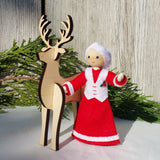 Mrs. Claus with wooden reindeer