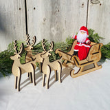 Santa Claus doll with wooden sleigh and reindeer