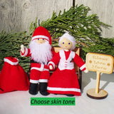 Santa Claus and Mrs. Claus Dolls sitting on bench